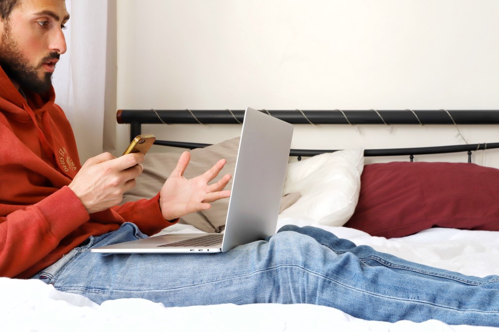 https://watt.co.uk/wp-content/uploads/2020/03/a-millennial-guy-using-laptop-and-mobile-phone-on-the-bed-and-working-from-home-remote-work_t20_AlZJ36.jpg