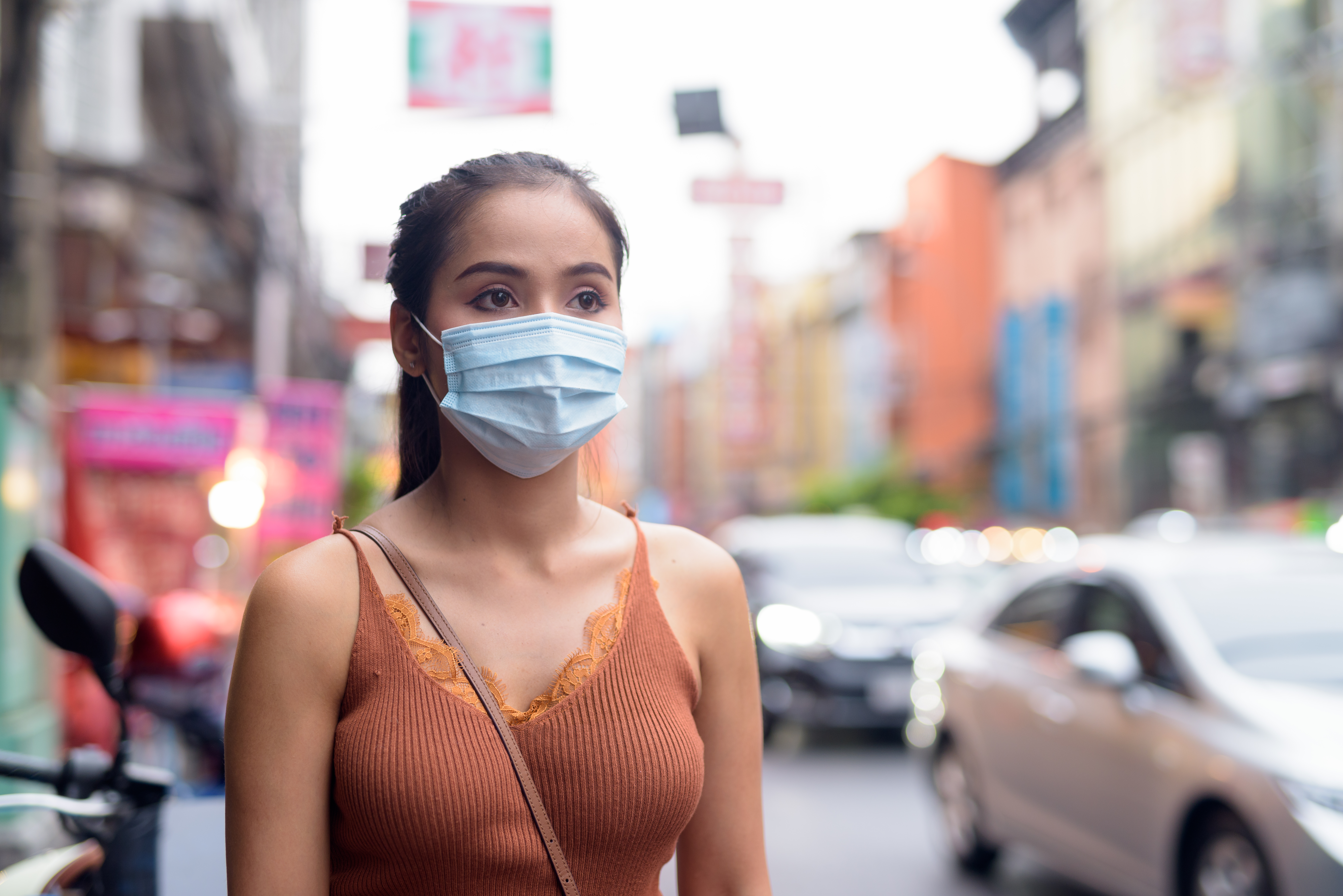 woman with surgical mask walking in the streets